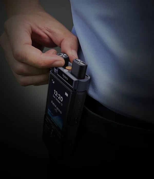 Push-to-talk over cellular radio clipped to a belt for UAE-wide event coverage rental
